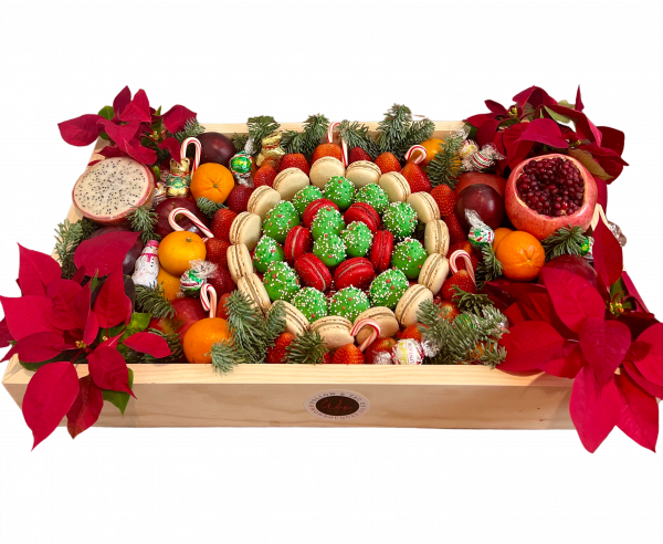 Christmas fruit box with fresh fruits and macarons and flowers