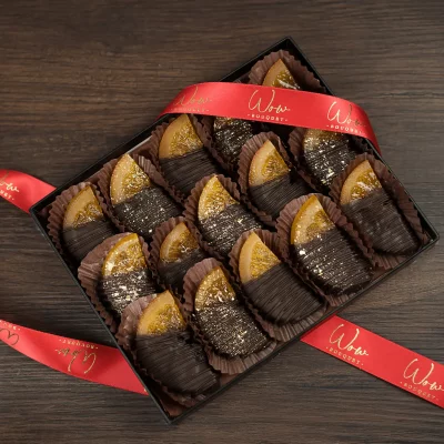 A decadent gift box featuring chocolate-covered orange slices, perfectly balancing the zesty freshness of citrus with rich dark chocolate.