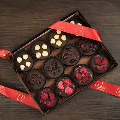 A luxurious gift box of 12 assorted French Chocolate Mendiants, blending smooth chocolate with crunchy toppings for a gourmet treat.