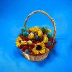 A beautifully arranged Ukrainian themed gift basket, emphasizing its vibrant color scheme and the mix of treats and sunflowers inside.
