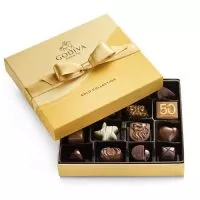 Close-up of assorted Godiva chocolates, showcasing their intricate designs, rich textures, and various fillings.