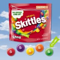 Close-up of colorful Skittles candies, showcasing their vibrant hues and signature 'S' imprint.