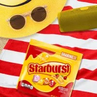 Close-up of unwrapped Starburst candies, showcasing their vibrant colors and square, chewy texture.