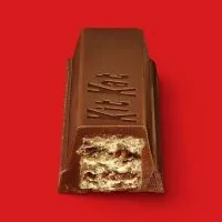 Close-up of a Kit Kat bar, showcasing its layers of crispy wafer covered in smooth milk chocolate