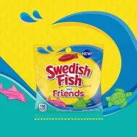 Close-up of red Swedish Fish candies, showcasing their distinct fish shape and gummy texture.
