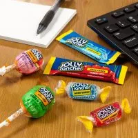 Close-up of assorted Jolly Rancher candies, showcasing their vibrant colors and translucent, hard texture.