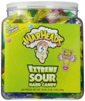 Close-up of Warheads candies, showcasing their round shape coated in sour sugar crystals.