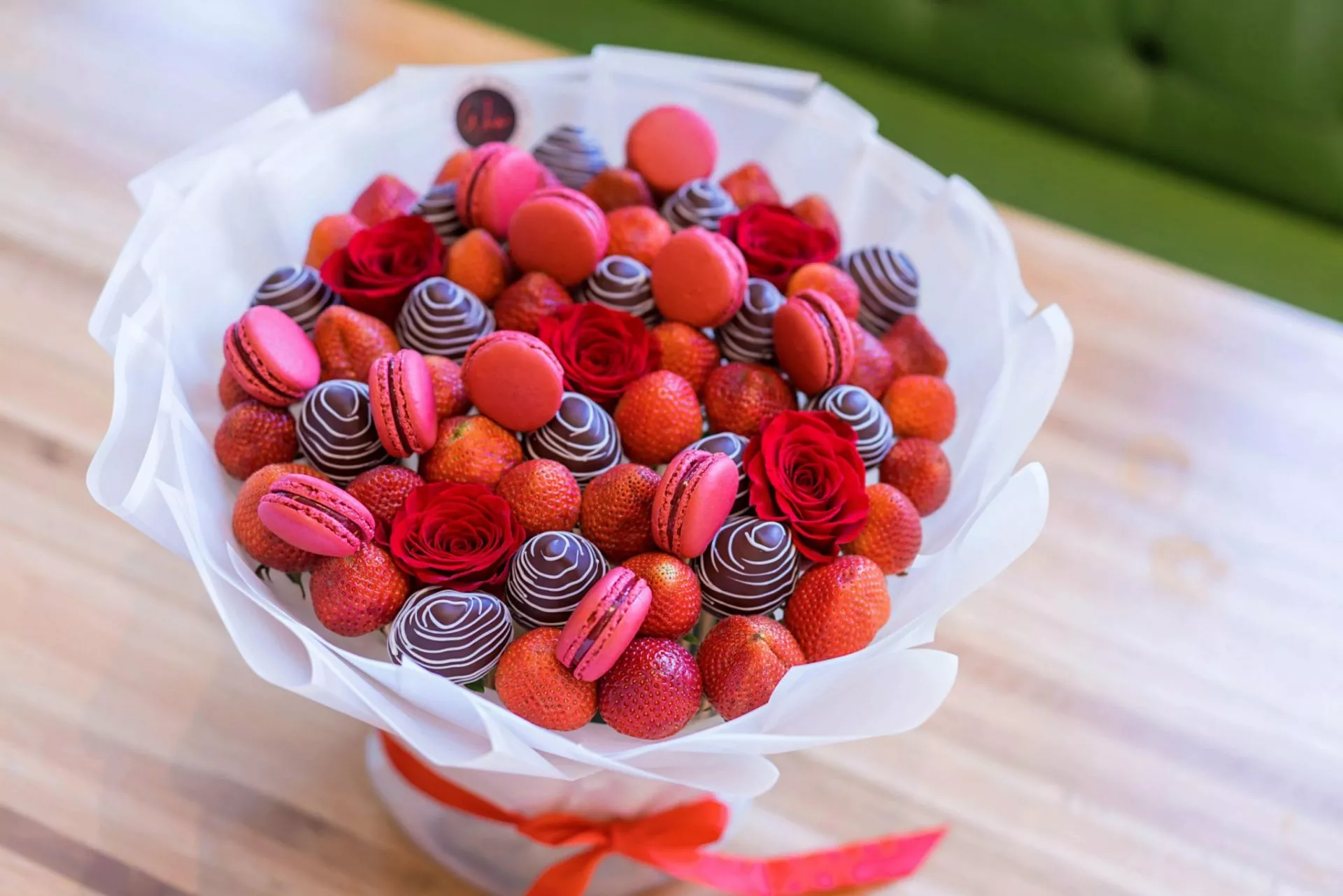 Manhattan Love Bouquet featuring fresh strawberries, roses, and macarons.