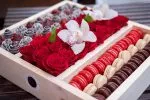 Elegant pairing of chocolate strawberries and pastel macarons.