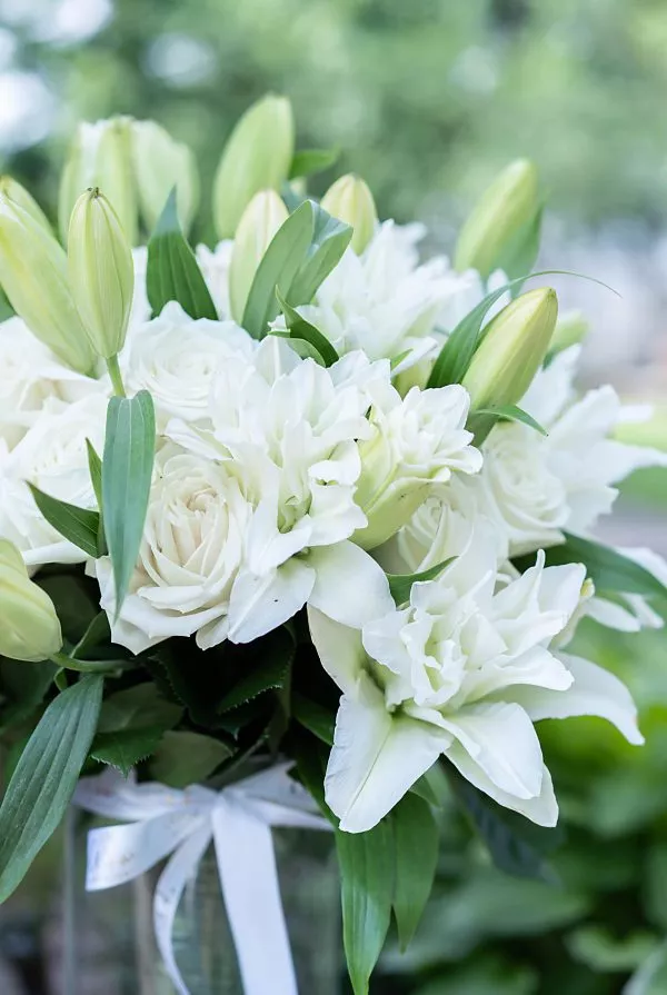 NYC-crafted 'Pure Serenity' bouquet, a harmonious blend of white roses and lilies.