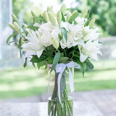 Elegant 'Pure Serenity' bouquet with white roses and lilies from NYC.