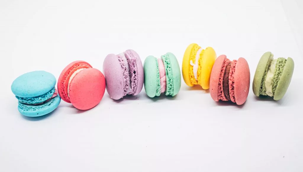 Pastel colored macarons sweet French dessert isolated on white background.