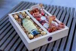 Premium wooden box showcasing a curated selection of NYC's gourmet delights