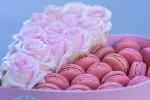 Roses and macarons combo in a heart container for a special occasion.
