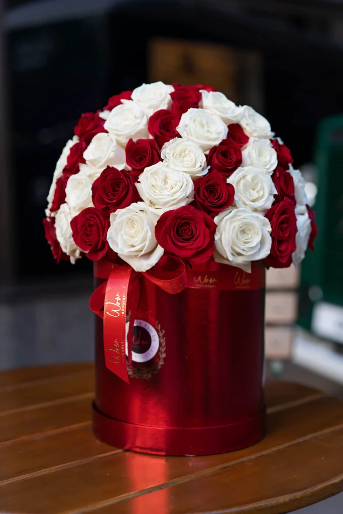 Close-up of red and white roses in a candy cane shape.