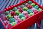 Top view of the open Holly Jolly box, showcasing the intricate arrangement of strawberries and macarons