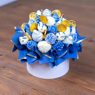 Hannukkah-themed chocolate-covered strawberries in elegant blue hues.