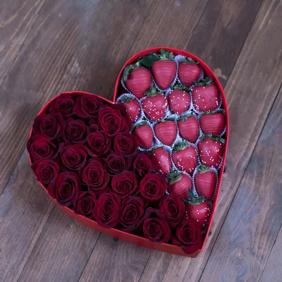 The Passionate Red Rose & Berry Box in an outdoor, romantic picnic setting.