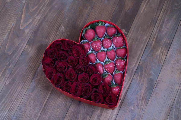 The Passionate Red Rose & Berry Box in an outdoor, romantic picnic setting.
