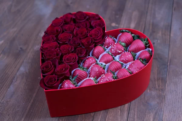 Overhead shot of the box, highlighting the arrangement of roses and strawberries.