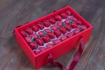 Elegant box of chocolate-covered strawberries and red macarons