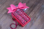 Handcrafted chocolate strawberries and macarons in a box