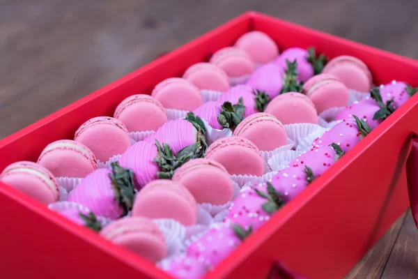 Gourmet pink strawberries and macarons in a deluxe box.