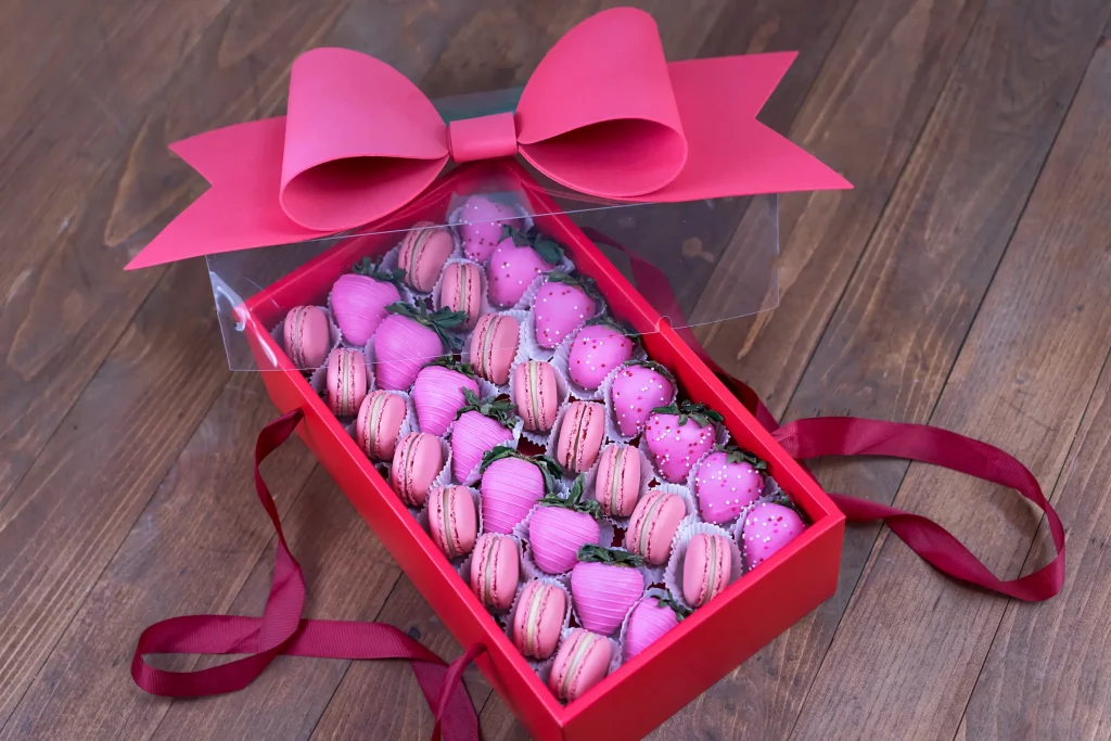 Pink chocolate-dipped strawberries in a luxury gift box.