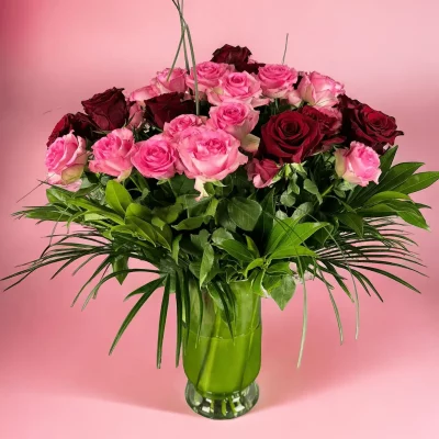 Elegant vase filled with 2 dozen pink and 2 dozen red roses for a romantic gesture