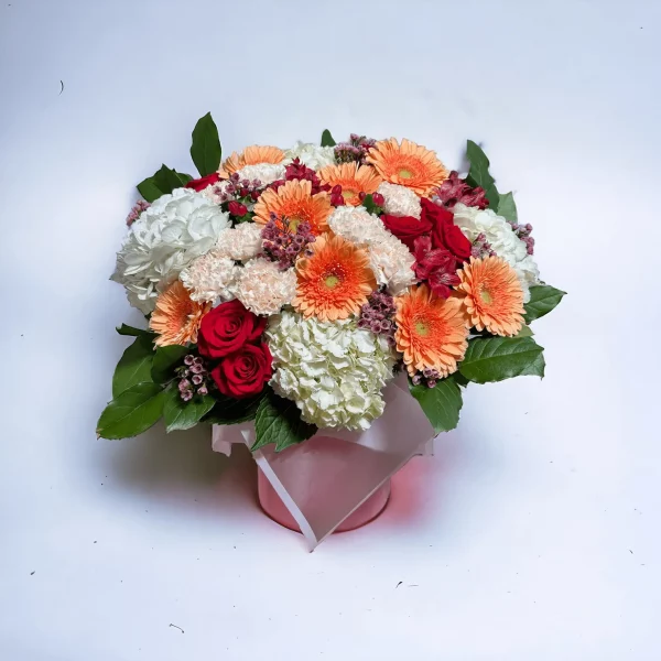 Picture of a spring-inspired floral arrangement, the Petal Palette, elegantly combining roses, carnations, and other vibrant seasonal flowers.