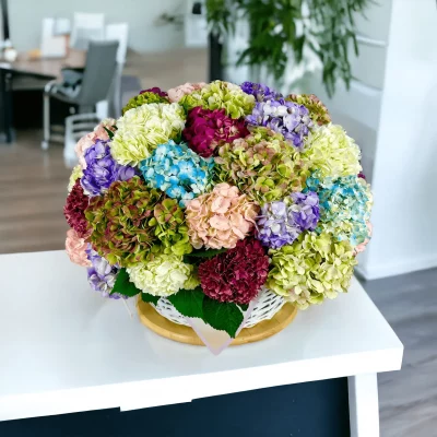 Overhead shot of a luxuriously designed hydrangea gift basket, densely packed with rich hydrangeas, creating a visually stunning floral display.