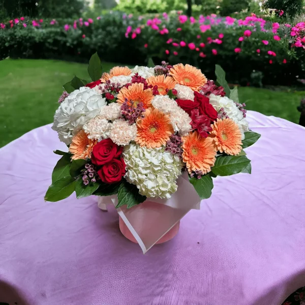 A detailed image of a spring floral arrangement, the Petal Palette, rich in colors and varieties, including spray roses and carnations, ideal for any springtime celebration.