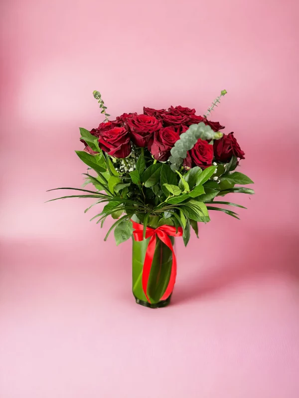 A stunning bouquet of 24 long-stemmed red roses arranged beautifully.