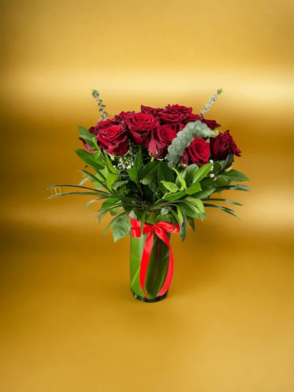 Freshly cut, bright red roses bundled together in a classic bouquet.