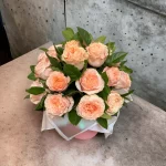 A delightful display of pink roses in a chic floral box