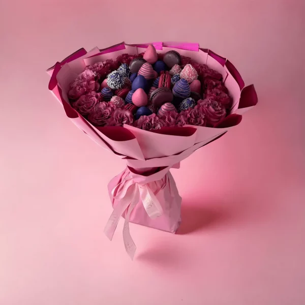 A romantic bouquet of radiant hot pink roses paired with decadent chocolate-covered strawberries, wrapped in decorative paper.
