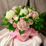 The Flower Box Allure, a premium floral arrangement in a hat box with a mix of delicate pink roses and hydrangeas, crafted for aesthetic allure.