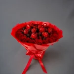 Fresh strawberries and red roses in a luxurious bouquet